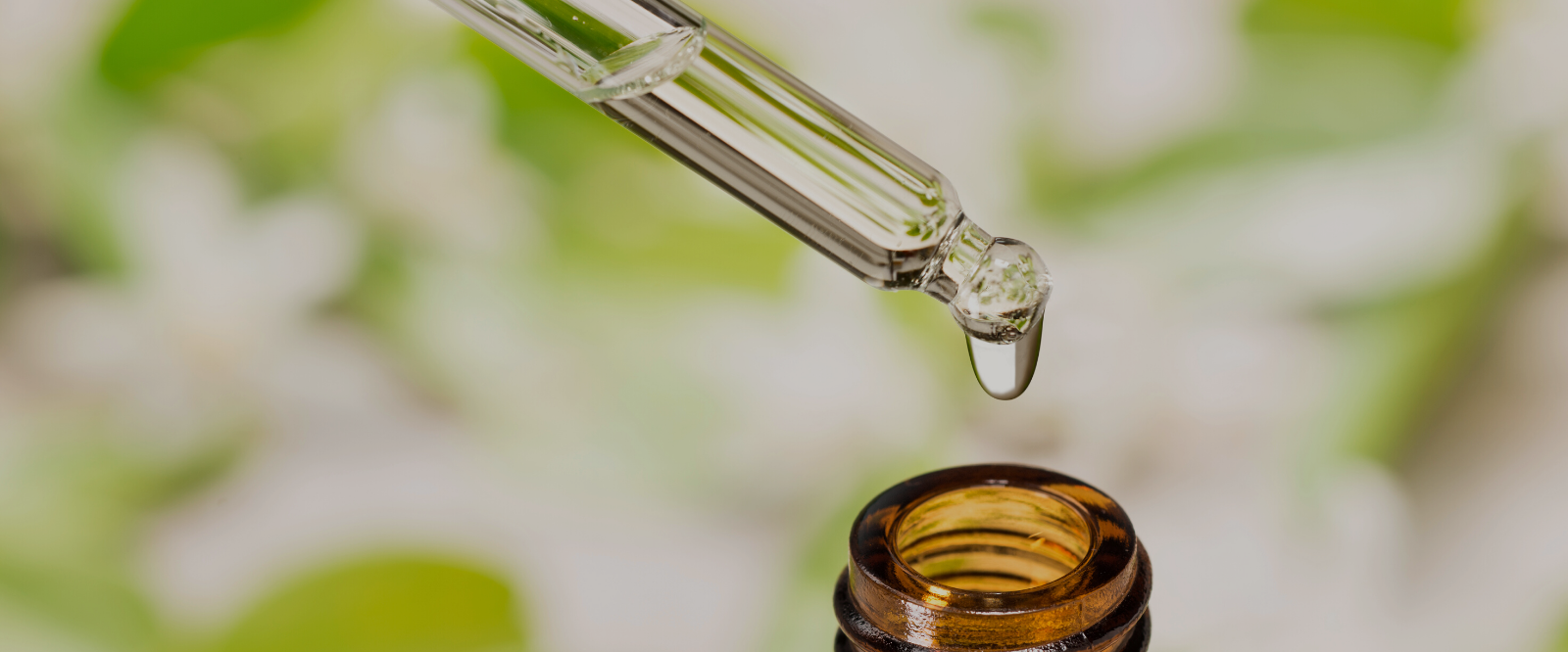 dripping essential oil into bottle of aroma spray perfume